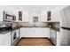 Modern kitchen with white cabinets and granite counters at 542 W Kingston Ave, Charlotte, NC 28203