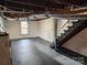 Unfinished basement with stairs and painted floor at 555 Old Wilkesboro Rd, Taylorsville, NC 28681