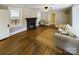 Cozy living room with a fireplace, hardwood floors, and ample natural light at 555 Old Wilkesboro Rd, Taylorsville, NC 28681