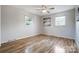 Bright bedroom with hardwood floors and ceiling fan at 6101 Davidson Dr, Matthews, NC 28104