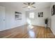 Hardwood floor bedroom with ceiling fan and neutral wall colors at 6101 Davidson Dr, Matthews, NC 28104