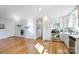 Modern kitchen with white cabinets, stainless steel appliances, and hardwood floors at 6101 Davidson Dr, Matthews, NC 28104