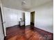 Simple bedroom with hardwood floors and access to other rooms at 703 Buffalo St, Shelby, NC 28150