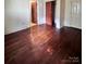 Main bedroom with hardwood floors and access to bathroom and closet at 703 Buffalo St, Shelby, NC 28150