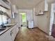 Kitchen with white cabinets, double sink, and access to other rooms at 703 Buffalo St, Shelby, NC 28150