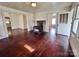Living room with hardwood floors, wood burning stove, and built-in shelving at 703 Buffalo St, Shelby, NC 28150