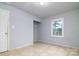 Bedroom with closet and window, featuring tile floors at 733 Milan E Rd, Charlotte, NC 28216