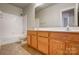 Clean bathroom with double vanity and a relaxing bathtub at 7750 Trailridge Dr, Tega Cay, SC 29708