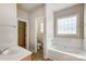 Bathroom with soaking tub, separate shower, and closet at 7750 Trailridge Dr, Tega Cay, SC 29708