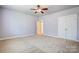 Spacious bedroom with double doors and a ceiling fan at 7750 Trailridge Dr, Tega Cay, SC 29708