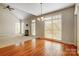Sunlit dining area with hardwood floors and large windows at 7750 Trailridge Dr, Tega Cay, SC 29708