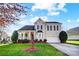 Two-story house with beige siding, a large front porch, and a two-car garage at 7750 Trailridge Dr, Tega Cay, SC 29708