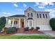 Two-story house with beige siding, a covered porch, and a brick walkway leading to the front door at 7750 Trailridge Dr, Tega Cay, SC 29708