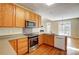 Modern kitchen with stainless steel appliances and wood cabinets at 7750 Trailridge Dr, Tega Cay, SC 29708