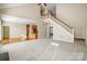 Two-story living room with hardwood floors and staircase at 7750 Trailridge Dr, Tega Cay, SC 29708