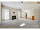 Open living room featuring a fireplace and hardwood floors at 7750 Trailridge Dr, Tega Cay, SC 29708