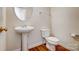 Clean powder room with pedestal sink and toilet at 7750 Trailridge Dr, Tega Cay, SC 29708