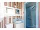 Bathroom with blue tile shower and striped wallpaper at 829 Rawlinson Rd, Rock Hill, SC 29732