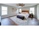 Main bedroom with hardwood floors, ceiling fan and large windows at 131 Nantz Ave, Mount Holly, NC 28120