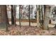 Wooded backyard with a fenced perimeter and shed at 133 Wellshire St, Mooresville, NC 28115