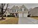 Two-story house with gray siding, two-car garage, and landscaping at 133 Wellshire St, Mooresville, NC 28115