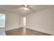 Bright, empty bedroom with hardwood floors, white walls, and a ceiling fan at 1330 Mulberry Ave, Charlotte, NC 28216