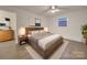 Cozy bedroom featuring a wooden bedframe, nightstands, and a plush rug at 1330 Mulberry Ave, Charlotte, NC 28216