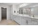 Bathroom with double vanity, walk-in shower, and a large mirror at 13725 Roderick Dr # 189, Huntersville, NC 28078