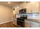 View of kitchen stove, microwave, and granite countertops at 138 Gray Willow St, Mooresville, NC 28117