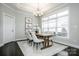 Bright dining room with wooden table, four chairs, and large window at 143 Valleymist Ln, Mooresville, NC 28117