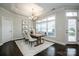 Bright dining room with wooden table, four chairs, and large window at 143 Valleymist Ln, Mooresville, NC 28117