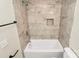 Clean bathroom with modern tub, shower, and tiled walls at 17608 Caldwell Track Dr, Cornelius, NC 28031