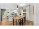 Modern kitchen and dining area with light wood table and chairs at 3301 Alcea St # 001, Charlotte, NC 28214