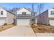 Charming two-story house with a blue and white exterior, attached garage, and landscaped front yard at 4015 Bufflehead Dr, Charlotte, NC 28269