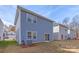 Backyard of two-story blue house with sliding glass door at 4015 Bufflehead Dr, Charlotte, NC 28269