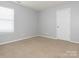 Empty bedroom with neutral carpet and white door at 4275 Tucker Chase Dr, Midland, NC 28107