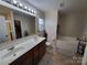 Double vanity, soaking tub, and separate shower in bathroom at 5003 Elementary View Dr, Charlotte, NC 28269