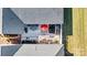 Lovely paved patio with red umbrella, landscaping, and firepit at 5019 Pleasant Run Dr, Matthews, NC 28104