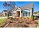 Gray craftsman style home with stone accents and landscaping at 5019 Pleasant Run Dr, Matthews, NC 28104