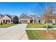 Gray craftsman style home with stone accents and landscaping at 5019 Pleasant Run Dr, Matthews, NC 28104