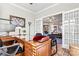 Home office features a large desk, built-in shelving, and French doors at 5019 Pleasant Run Dr, Matthews, NC 28104