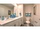 Bathroom with double vanity, white cabinets, and teal accents at 5163 Hyrule Dr, Charlotte, NC 28262