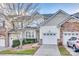 Front view of townhome with attached garage and landscaping at 610 Pine Links Dr, Fort Mill, SC 29708