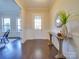 Welcoming entryway with a white door, dark wood floors, and a decorative table at 6723 Eliah Dr, Weddington, NC 28104