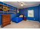 Blue bedroom with shelves, a twin bed, and a ceiling fan at 7812 Hwy 742 Hwy, Marshville, NC 28103