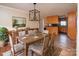 Dining room with wood floors, large table, and view of the kitchen at 7812 Hwy 742 Hwy, Marshville, NC 28103