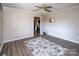 Living room with wood-look flooring, ceiling fan, and view to the kitchen at 7812 Hwy 742 Hwy, Marshville, NC 28103