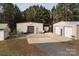 Metal outbuildings with garage doors, a carport, and a gravel driveway at 7812 Hwy 742 Hwy, Marshville, NC 28103