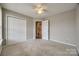 Bedroom with carpeted floors, ceiling fan, closet, and ensuite bathroom access at 828 Holdcroft Ln, Rock Hill, SC 29730