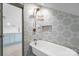 Elegant bathroom with clawfoot tub, patterned tile, and modern fixtures at 8478 Rocky River Rd, Harrisburg, NC 28075